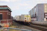  Tail end of 28X passes between the old CNJ Station and Self Storage Facility.   